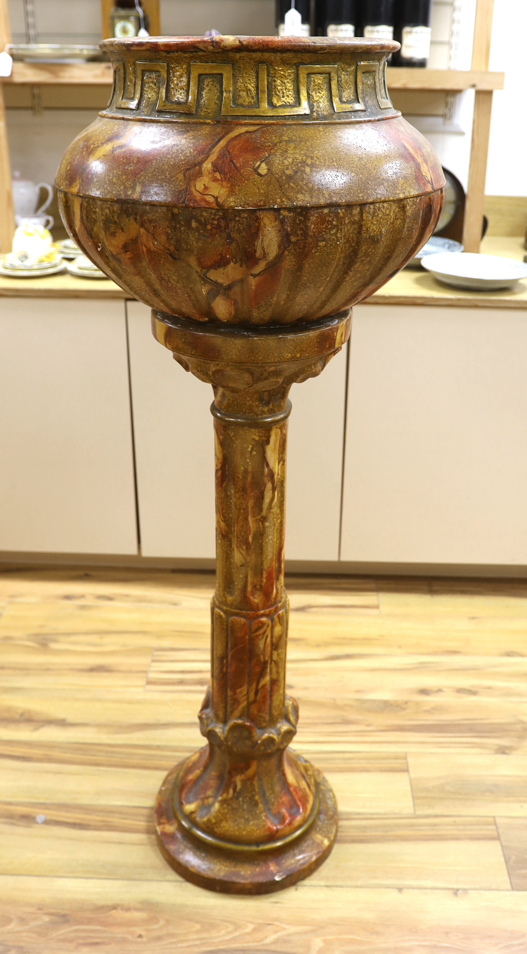 A large faux marble pottery jardiniere on stand, 126cm total height